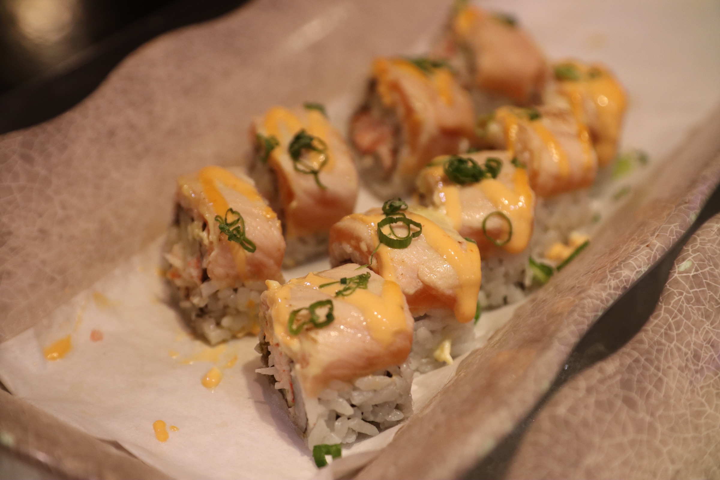Salmon-topped sushi rolls prepared at LaMeiZi